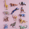 Set of colorful animal figurines on a pink background